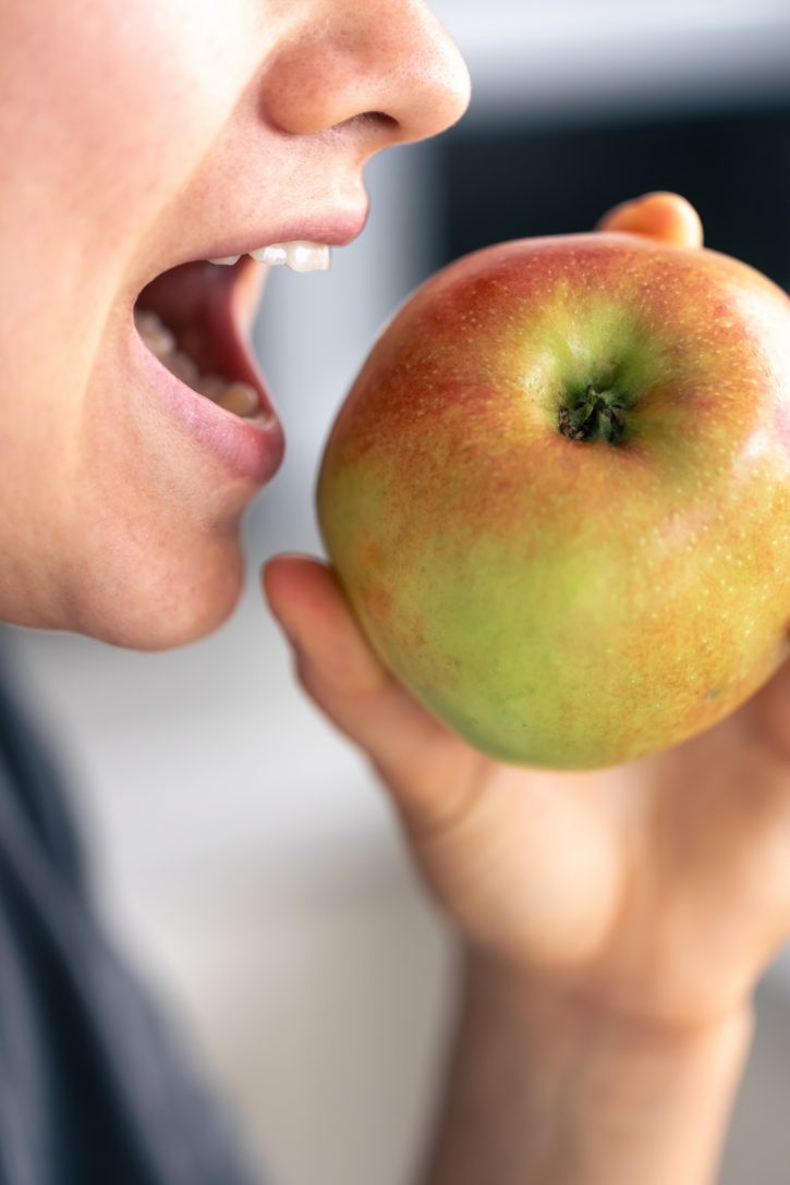 Person About To Bite Apple