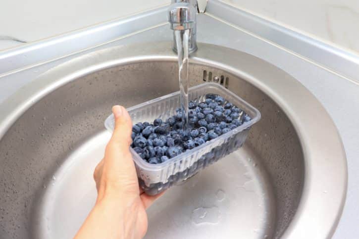 Washing Blueberries Under Running Water