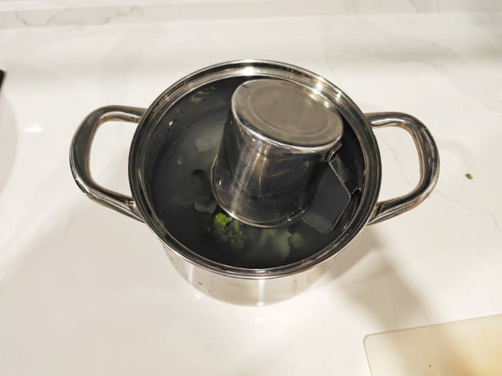 Holding Broccoli Down With Cup