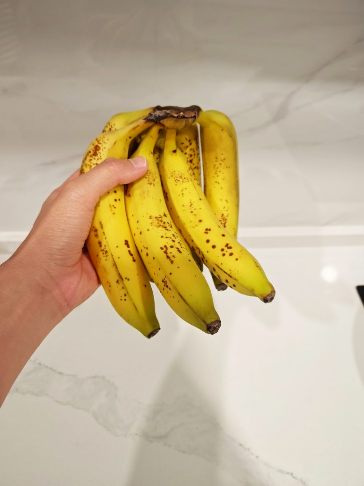 Green Tipped Bananas With Brown Spots