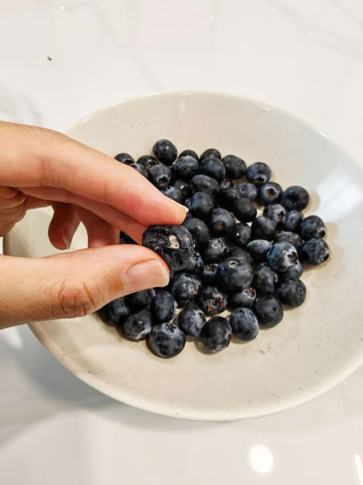 Moldy Blueberry Among Fresh Berries