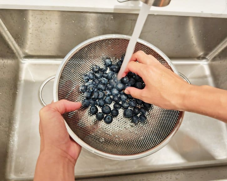 Rinsing Fresh Blueberries In Sink